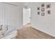 This bedroom has white walls, a tan carpet, a comfortable papasan chair, and a closet with white doors at 414 Lancaster Ave, Orange City, FL 32763
