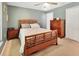 Comfortable bedroom with wooden furniture, neutral carpet, and natural light at 414 Lancaster Ave, Orange City, FL 32763