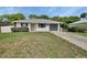 A charming house with a gray roof, a driveway, and a manicured lawn at 414 Lancaster Ave, Orange City, FL 32763