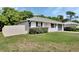 Single story home with green lawn and an attached one-car garage, enclosed by a vinyl fence at 414 Lancaster Ave, Orange City, FL 32763