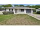 Charming single-story home features a well-maintained lawn, gray roof and an attached one car garage at 414 Lancaster Ave, Orange City, FL 32763