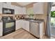 Bright kitchen featuring stainless steel appliances, black countertops and yard view at 414 Lancaster Ave, Orange City, FL 32763