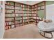 A well-organized office boasting custom wooden bookshelves spanning two walls and a comfortable papasan chair at 414 Lancaster Ave, Orange City, FL 32763