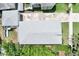 Birds-eye view of home with small pool, green backyard, and long driveway at 417 S Palmetto Ave, Daytona Beach, FL 32114