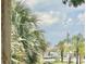 Serene view with swaying palm trees, clear blue skies and a calm bay with boats docked at 417 S Palmetto Ave, Daytona Beach, FL 32114