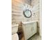 Nautical themed half bathroom with wood-look tile and unique, round mirror at 417 S Palmetto Ave, Daytona Beach, FL 32114