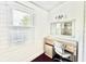 Cozy bathroom nook with shiplap walls, vanity, mirror, and natural light at 417 S Palmetto Ave, Daytona Beach, FL 32114
