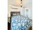 Cozy bedroom features a blue floral bedspread, modern light fixture, and built-in wardrobe for ample storage at 417 S Palmetto Ave, Daytona Beach, FL 32114