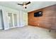 Bedroom with a wall mounted TV, ceiling fan, and sliding door closet at 417 S Palmetto Ave, Daytona Beach, FL 32114