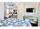 Bedroom view to living area featuring a mounted TV, a built in fireplace and a quaint desk at 417 S Palmetto Ave, Daytona Beach, FL 32114
