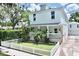 Charming two-story home with a well-manicured lawn, white picket fence, and inviting front porch at 417 S Palmetto Ave, Daytona Beach, FL 32114