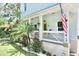 Inviting front porch with a lime green door, landscaping and an American flag at 417 S Palmetto Ave, Daytona Beach, FL 32114