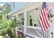 Inviting front porch with a lime green door and an American flag at 417 S Palmetto Ave, Daytona Beach, FL 32114