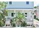 A cozy front porch with lush tropical landscaping and a view of the house number at 417 S Palmetto Ave, Daytona Beach, FL 32114