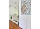 Bright hallway with hardwood floors, white railing, and a modern art piece at 417 S Palmetto Ave, Daytona Beach, FL 32114