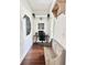 Hallway with wooden floors featuring a lion portrait and a small workstation at 417 S Palmetto Ave, Daytona Beach, FL 32114