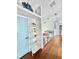 Hallway boasts light wood floors, stylish decor, and a charming turquoise door at 417 S Palmetto Ave, Daytona Beach, FL 32114