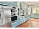 Modern kitchen featuring stainless steel appliances, custom cabinetry, wood countertops and floors and corrugated steel wall at 417 S Palmetto Ave, Daytona Beach, FL 32114