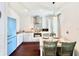 Cozy kitchen with white cabinets, stainless steel appliances, and a dining table at 417 S Palmetto Ave, Daytona Beach, FL 32114
