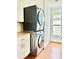 Efficient laundry area with stacked washer/dryer, white cabinets and a window at 417 S Palmetto Ave, Daytona Beach, FL 32114