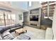 Open-concept living area with stone accent wall, fireplace, and staircase, adjacent to outdoor living space at 417 S Palmetto Ave, Daytona Beach, FL 32114