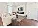 Bright living room with fireplace, hardwood floors, and neutral decor at 417 S Palmetto Ave, Daytona Beach, FL 32114