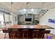 Open-concept living area featuring a kitchen island, modern lighting, a stone accent wall, and an aquarium at 417 S Palmetto Ave, Daytona Beach, FL 32114