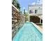 Outdoor pool with a stone waterfall feature and lush greenery at 417 S Palmetto Ave, Daytona Beach, FL 32114