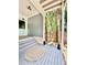 Covered porch with stylish décor, including unique wall paneling and an outdoor rug at 417 S Palmetto Ave, Daytona Beach, FL 32114