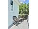 Charming porch features two rocking chairs and views of lush greenery at 417 S Palmetto Ave, Daytona Beach, FL 32114