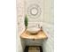Stylish powder room featuring a vessel sink, decorative mirror, and custom wall finishes at 417 S Palmetto Ave, Daytona Beach, FL 32114