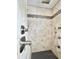 Elegant shower with neutral tile and mosaic accents at 417 S Palmetto Ave, Daytona Beach, FL 32114