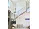 Modern staircase with metal railings and wood treads adjacent to a stone accent wall and aquarium at 417 S Palmetto Ave, Daytona Beach, FL 32114
