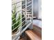 Modern staircase with wood treads and metal railings with indoor plants at 417 S Palmetto Ave, Daytona Beach, FL 32114