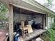 Outdoor covered porch space featuring rustic decor, a chair, and a storage area at 43721 State Road 19, Altoona, FL 32702