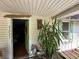 Home's front entrance featuring the house number, decorative plants, and a cozy doorway at 43721 State Road 19, Altoona, FL 32702