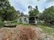 Exterior home view with a covered porch and a yard, surrounded by mature trees at 43721 State Road 19, Altoona, FL 32702