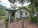 Charming home featuring a cozy porch and a fenced yard surrounded by mature trees at 43721 State Road 19, Altoona, FL 32702