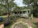 Charming cottage-style home featuring a cozy covered porch and beautifully landscaped front yard at 43721 State Road 19, Altoona, FL 32702