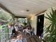Covered porch featuring seating, potted plants, and a glimpse of outdoor living space at 43721 State Road 19, Altoona, FL 32702