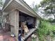 Covered porch area with an assortment of furniture and storage at 43721 State Road 19, Altoona, FL 32702