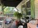 Relaxing porch setup with greenery, chair, table, and plants creating a serene outdoor space at 43721 State Road 19, Altoona, FL 32702