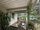 Rustic porch with potted plants and weathered wood features, offering a charming outdoor space at 43721 State Road 19, Altoona, FL 32702