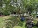 Spacious yard with outdoor seating, shaded by mature trees for relaxing and entertaining at 43721 State Road 19, Altoona, FL 32702