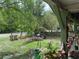 Inviting yard view from the porch, featuring well-maintained landscaping and mature trees at 43721 State Road 19, Altoona, FL 32702