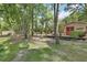 Private backyard with a shed and inviting deck space, surrounded by mature trees at 535 Black Ironwood Dr, Deland, FL 32724