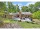 Charming backyard featuring a brick house, patio, and outdoor furniture at 535 Black Ironwood Dr, Deland, FL 32724