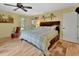 Relaxing bedroom featuring a ceiling fan, wood floors, and natural light at 535 Black Ironwood Dr, Deland, FL 32724