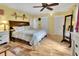 Bedroom featuring wood floors, a full-length mirror, and double closets at 535 Black Ironwood Dr, Deland, FL 32724