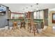 Stylish kitchen bar with wooden stools and a clear view of the adjacent cooking and prep area at 535 Black Ironwood Dr, Deland, FL 32724